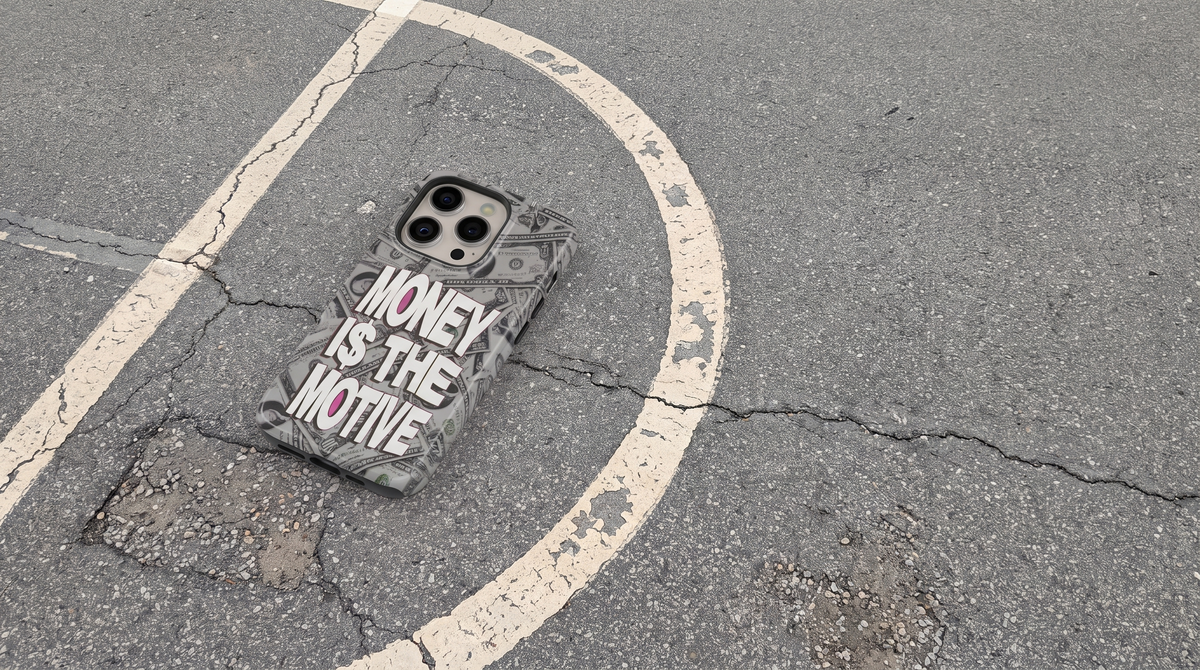 Money i$ The Motive iPhone tough case on the cracked asphalt of an outdoor basketball court